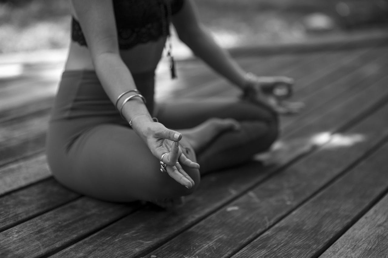 A person practicing yoga in outdoor setting, focusing on meditation and mindfulness.